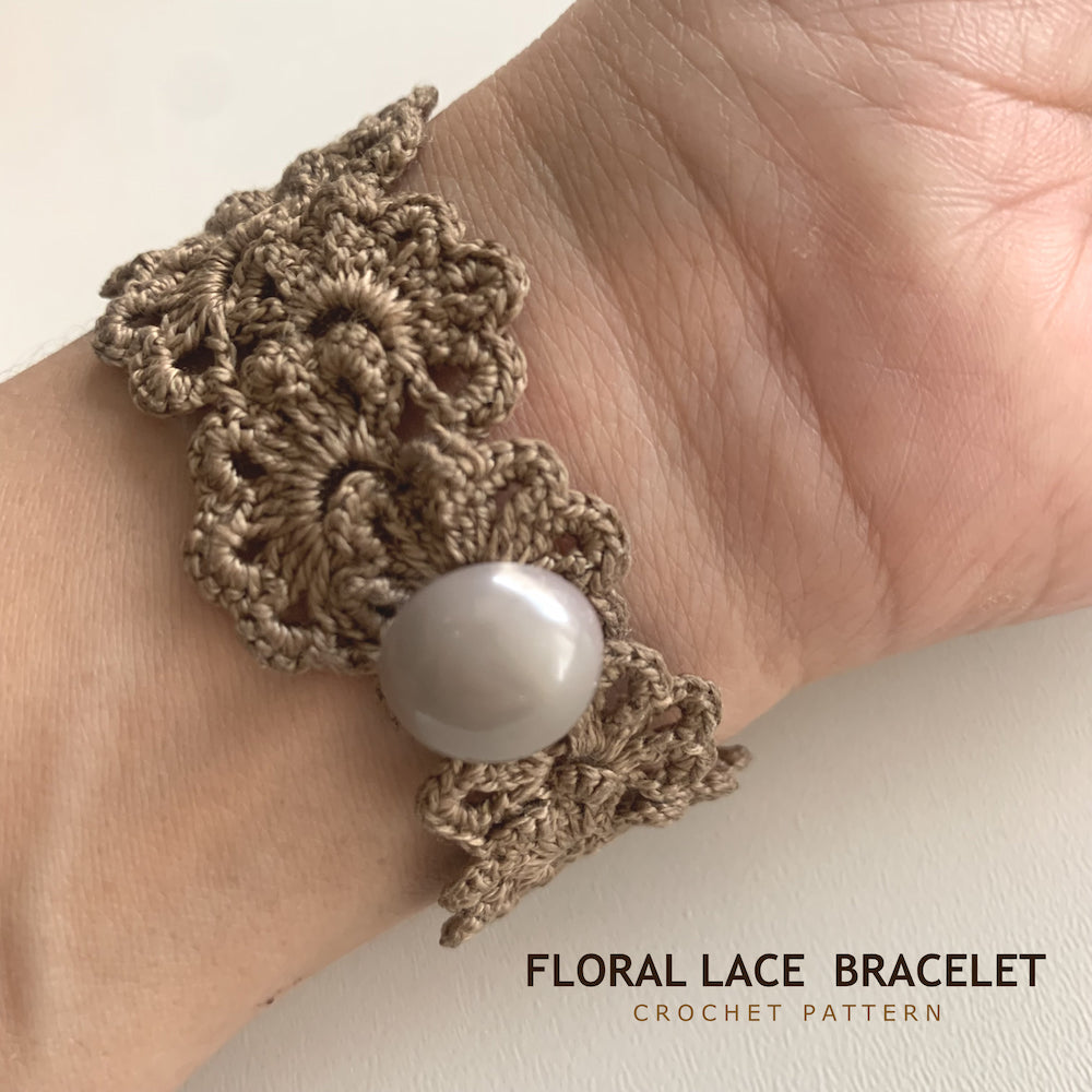 A close-up of a crocheted floral lace bracelet worn on a wrist, featuring a white pearl accent. Text at the bottom reads 'FLORAL LACE BRACELET CROCHET PATTERN'.