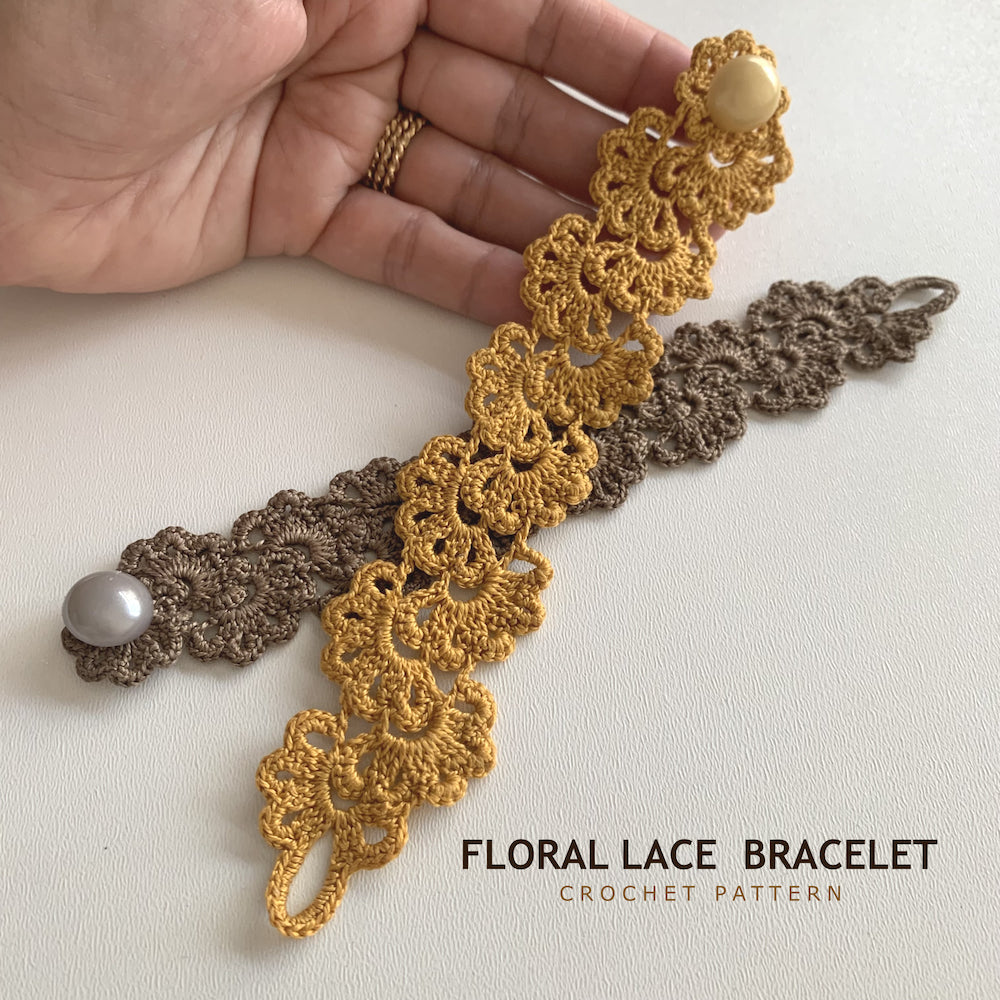 A hand holds a floral lace crochet bracelet in mustard yellow with a cream pearl, with a second brown lace bracelet laid behind it on a light background. Text at the bottom reads 'FLORAL LACE BRACELET CROCHET PATTERN'.